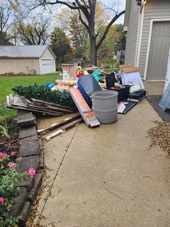 Dumpster being loaded with debris for Roofing Dumpster Rental in South Hill